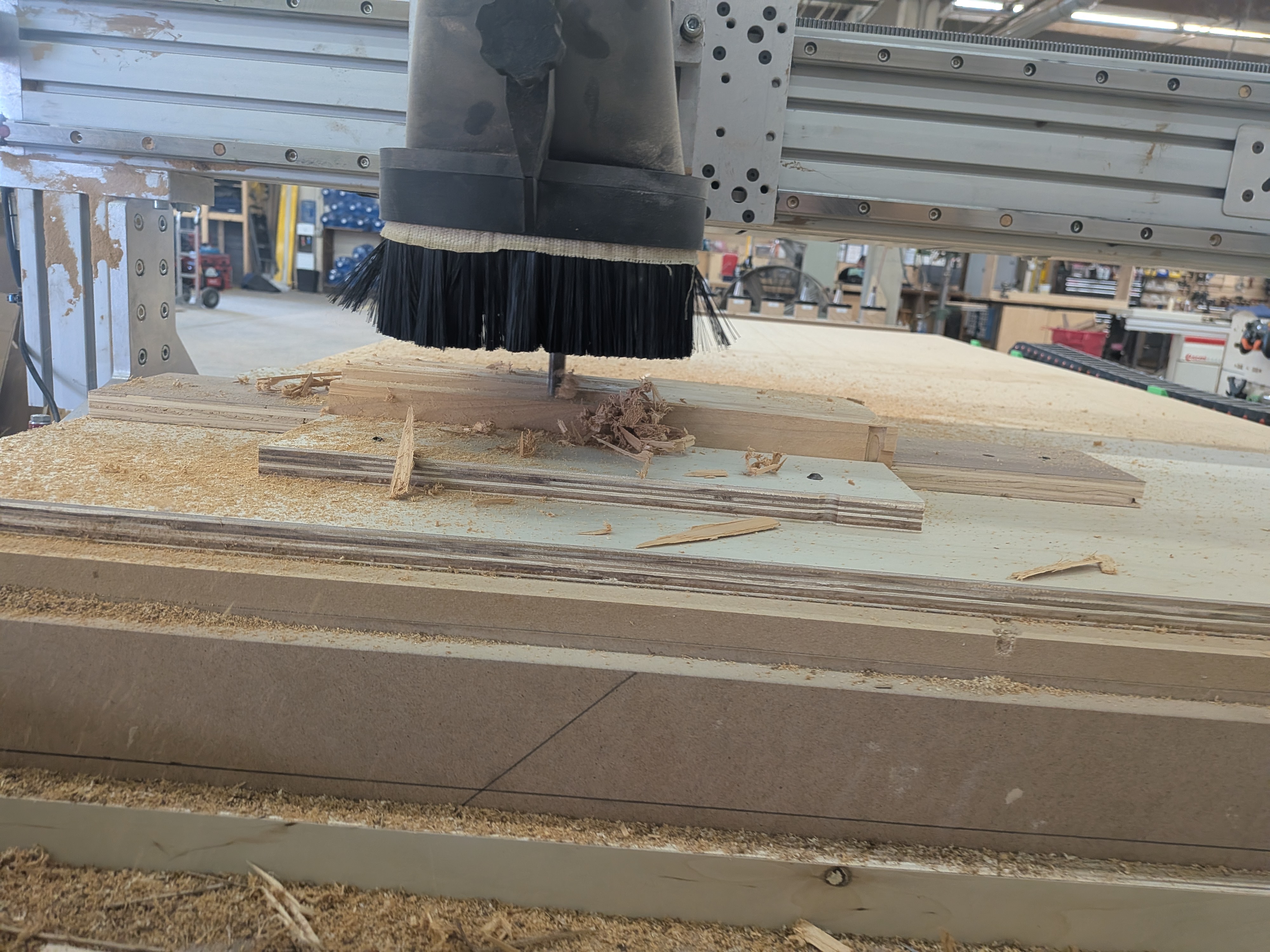 CNC spindle cutting into the sculpture blank on the inset table