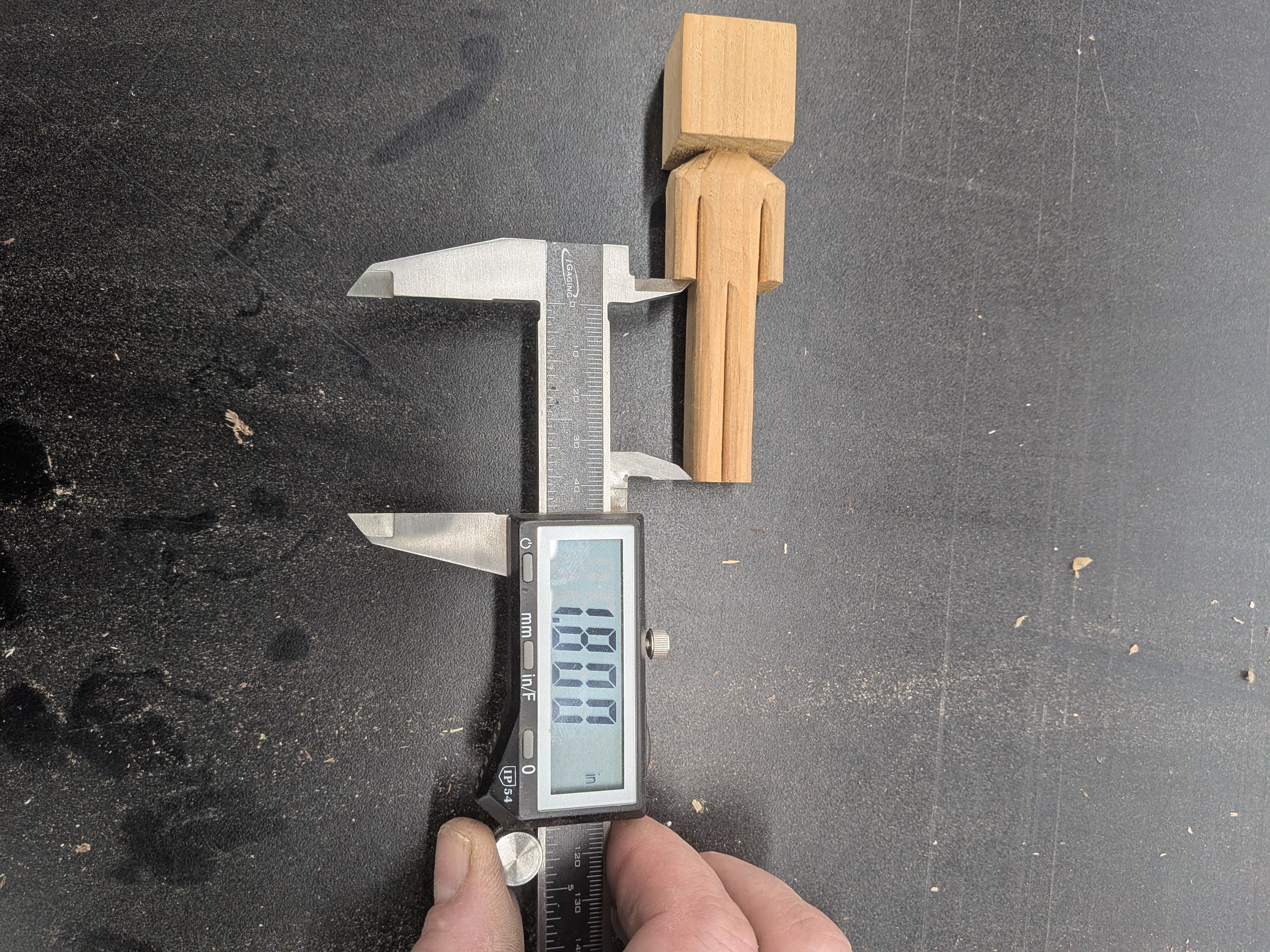 Scale model of the sculpture being measured with calipers — 180mm height